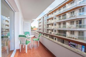 a balcony with a table and chairs and a building at Curling in Port d'Alcudia