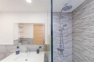 a bathroom with a shower and a white sink at Bon Estar in Port d'Alcudia +37 photos
