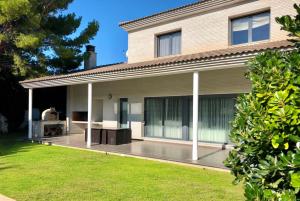 a house with a deck in front of it at ARENDA Villa Perla in Hospitalet de l'Infant