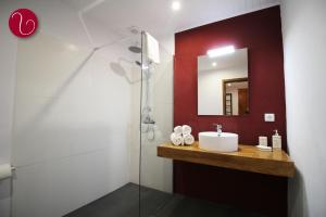 a bathroom with a sink and a mirror at GuestHouse Vila Lusitania in Funchal +34 photos
