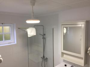 a bathroom with a shower and a glass shower stall at Apartamentos y Bungalows Finca Colón in Fuencaliente de la Palma