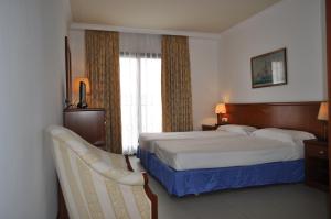 a hotel room with a bed and a window at Hostal Vila del Mar in Lloret de Mar +23 photos