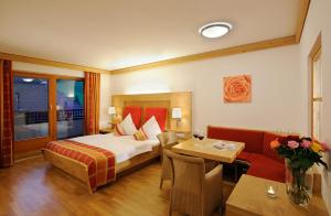 pokój hotelowy z łóżkiem i stołem w obiekcie Hotel Marten - Joker Card Partner w Saalbach Hinterglemm +37 zdjęć