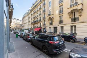 a black car parked on the side of a city street at CMG Palais des Congrès/ Ternes in Paris