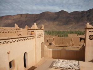 a view of a building with mountains in the background at kasbah timidarte in Zaouïta Bou Lhâssane