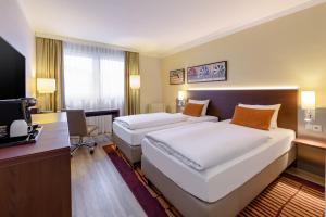 Postel nebo postele na pokoji v ubytování Mercure Hotel Duisburg City