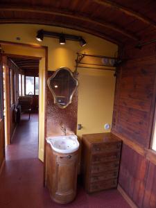 a bathroom with a sink and a mirror on the wall at Camping Insolite Le Haut Village in Saint-Michel-Chef-Chef
