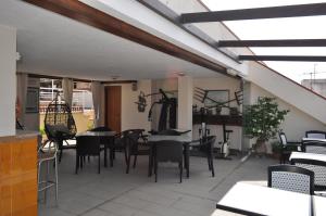 a patio with tables and chairs and a dining room at Hostal Vila del Mar in Lloret de Mar
