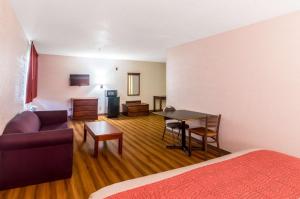 a living room with a couch and a table at Motel 6-Oklahoma City, OK in Oklahoma City