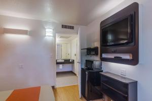 a living room with a flat screen tv on a wall at Motel 6-Ardmore, OK in Ardmore