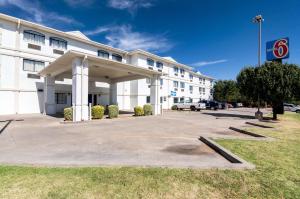 a large white building with a parking lot at Motel 6-Oklahoma City, OK in Oklahoma City