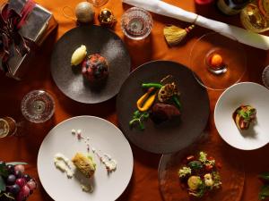 a wooden table with plates of food on it at Le Grand Karuizawa Hotel and Resort in Karuizawa
