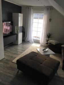 a living room with a couch and a table at Zur Burgmauer in Welschbillig +7 photos