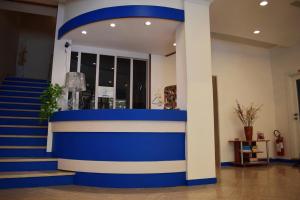 a blue and white wall in a room with stairs at Hotel Arno in Misano Adriatico