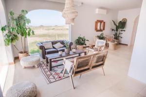 a living room with a couch and a table and chairs at Dreamsea Surf Guest House in Sintra