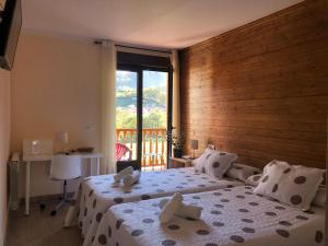 a bedroom with a bed and a large window at Alojamiento Rural Cosorios in Cangas de Onís