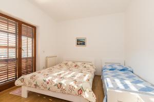 Postel nebo postele na pokoji v ubytování Apartments Villa Adria
