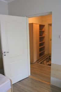 an empty room with a white door and a closet at Dom Litewski in Sejny