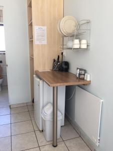 a kitchen with a table and a toilet in a room at Blue Skies Country House in Lorraine