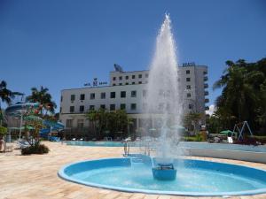 a water fountain in front of a building at Hotel Brasil in São Lourenço