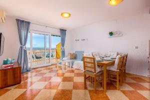 a dining room with a table and a view of the ocean at Apartments Villa Maria in Crikvenica