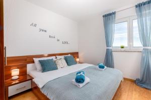 a bedroom with two beds with stuffed animals on them at Apartments Villa Maria in Crikvenica