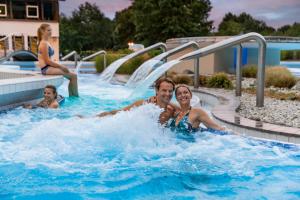 a man and a woman in a swimming pool at Hotel Sonnenhof in Bad Birnbach
