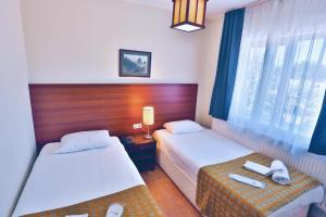 A bed or beds in a room at The Green Park Kartepe