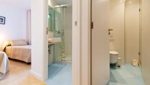 a bathroom with a toilet and a sink at Apartamento Blue Carabela in Alcudia +33 photos
