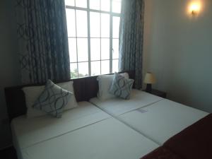 Voodi või voodid majutusasutuse Global Towers Hotel & Apartments toas