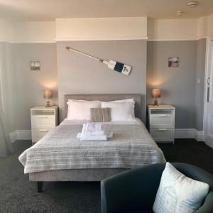 a bedroom with a bed with a lamp on it at The Blenheim in Dawlish