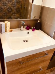a white sink in a bathroom with a mirror at flAle's holiday house in Cefalù