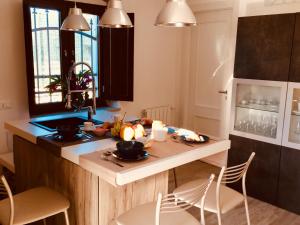 a kitchen with a counter with a table and chairs at flAle's holiday house in Cefalù