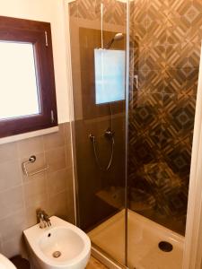 a bathroom with a shower and a toilet and a sink at flAle's holiday house in Cefalù +29 photos