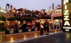 a restaurant with people sitting on top of a building at 24 Seven Boutique Hotel in Malia +37 photos