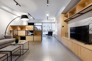 a living room with a couch and a tv at Ermou str. Elegant Apartments by UPSTREET in Athens