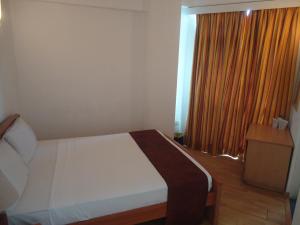 Voodi või voodid majutusasutuse Global Towers Hotel & Apartments toas