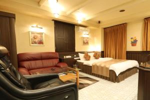 a hotel room with a bed and a couch at AURA Resort Nara (Adult Only) in Nara