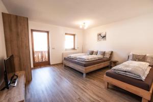 Łóżko lub łóżka w pokoju w obiekcie Apartments Wimpissinger