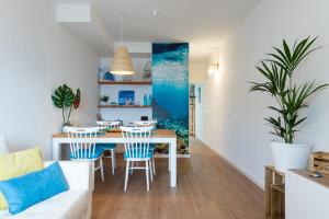 a dining room and living room with a table and chairs at DELUXE HOME, SEA VIEW AND TERRACE GC52 in Arucas