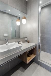 a bathroom with a sink and a shower at Luxury Apartments in Plaka by UPSTREET in Athens