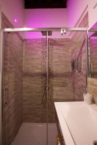 a bathroom with a shower with a glass door at Navona Sweet Home in Rome +26 photos