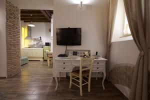 a living room with a desk and a tv on the wall at Navona Sweet Home in Rome