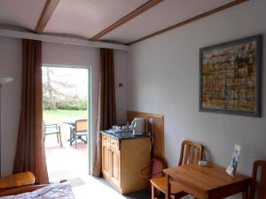 a room with a table and a kitchen with a dining room at The Green House in Kołczewo