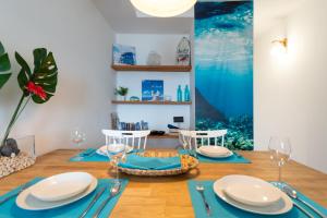 a dining room with a table with blue napkins and glasses at DELUXE HOME, SEA VIEW AND TERRACE GC52 in Arucas