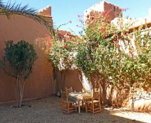 a patio with a table and chairs and trees at kasbah timidarte in Zaouïta Bou Lhâssane +32 photos