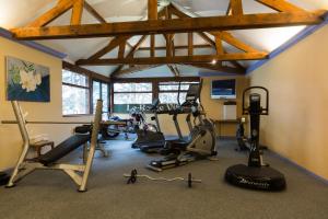 a gym with several exercise equipment in a room at The Originals Access, Hôtel La Dousseine, Dreux Nord (Inter-Hotel) in Anet