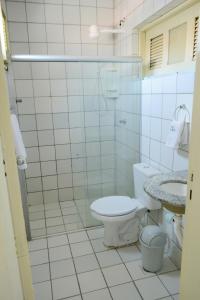 a bathroom with a toilet and a sink at Hotel Villa Real in Sobral