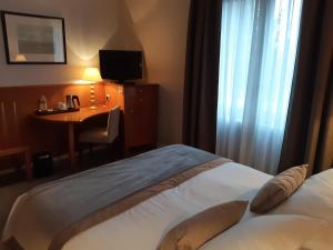 Postel nebo postele na pokoji v ubytování Hôtel & Restaurant Le Relais d'Aumale
