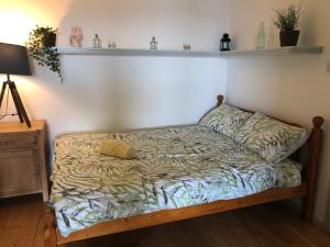 a bed in a room with a shelf on the wall at Clifden Bay Apartment in Clifden